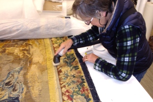 The reverse of the tapestry is vacummed once the lining is removed. 