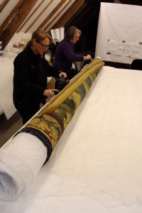 The front of the tapestry is vacummed as we roll it. 