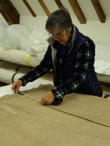 Sue documents the lining, measuring the components of the tapestry hanging mechanism. 